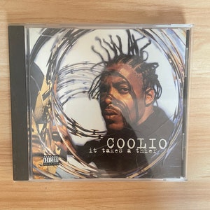 May include: A CD case with a black and white image of Coolio. The text "Coolio" and "it takes a thief" are printed on the front of the case. The case has a Parental Advisory sticker on the bottom left corner.