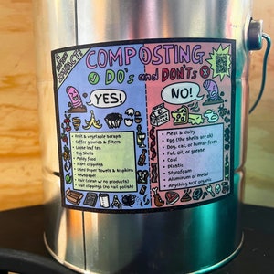 May include: A silver compost bin with a colorful sticker that says "COMPOSTING DO's and DON'TS". The sticker has a list of items that can and cannot be composted, including fruit and vegetable scraps, coffee grounds, loose leaf tea, egg shells, moldy food, plant clippings, used paper towels, newspaper, hair, and nail clippings. The sticker also includes a list of items that cannot be composted, including meat and dairy, eggshells, dog, cat, or human feces, fat, oil, or grease, coal, plastic, styrofoam, aluminum or metal, and anything not organic.