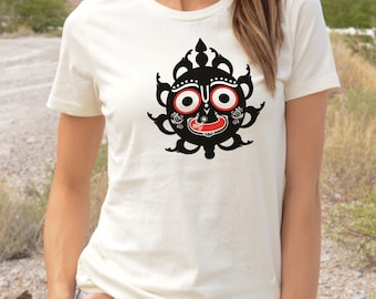 May include: A white t-shirt featuring a black and red graphic of a sun with a face. The face has large eyes, a red mouth, and a third eye on the forehead.