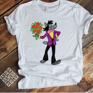 May include: White t-shirt with a cartoon wolf wearing a purple suit and a bow tie, holding a bouquet of red roses.