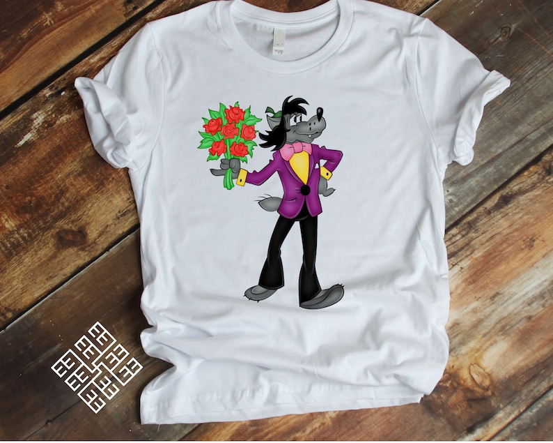 May include: White t-shirt with a cartoon wolf wearing a purple suit and a bow tie, holding a bouquet of red roses.
