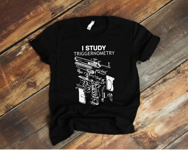 May include: Black t-shirt with a white graphic of a gun disassembled with the text "I study triggernometry".