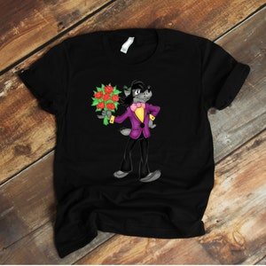 May include: Black t-shirt with a cartoon wolf wearing a purple suit and holding a bouquet of red roses.
