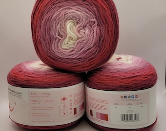 May include: Three balls of ombre yarn in shades of pink, red, and white. The yarn is 100% acrylic and is 5.3 ounces or 150 grams. The yarn is 590 yards or 540 meters long. The yarn is made in Turkey.