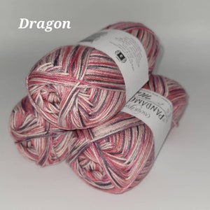 May include: Three balls of yarn in a pink, white, and gray striped pattern. The yarn is labeled "Cassia Yarn Panda The Collection" and "Dragon".