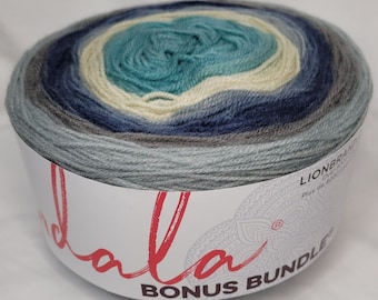 May include: A skein of Lion Brand Mandala yarn in the colorway "Lionbrand Mandala - Bonus Bundle - Ocean Breeze". The yarn is a gradient of blue, gray, and white.