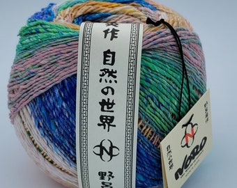 May include: A ball of multi-colored yarn with a white label that reads "Noro 自然色糸"
