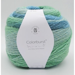 May include: A ball of variegated yarn in blue and green hues. The label reads "Colorburst" by Universal Yarn, with the slogan "Knit, Relax, Smile, Repeat!"