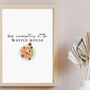 May include: A framed print with the text "deep conversations at the WAFFLE HOUSE" and a cartoon illustration of a waffle with blueberries and raspberries on a blue plate.