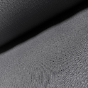 Puede incluir: Primer plano de una tela gris con un sutil patrón de cuadrícula. La tela está doblada, creando sombras y resaltando la textura. El material parece duradero y posiblemente resistente al agua, adecuado para diversas aplicaciones.