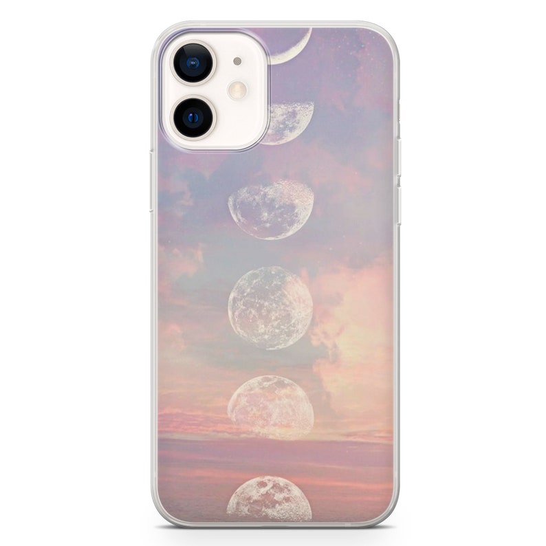 May include: A clear phone case with a design of a pink and orange sunset with white moons in different phases.