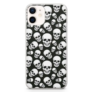 May include: A clear phone case with a black background and a white skull pattern.