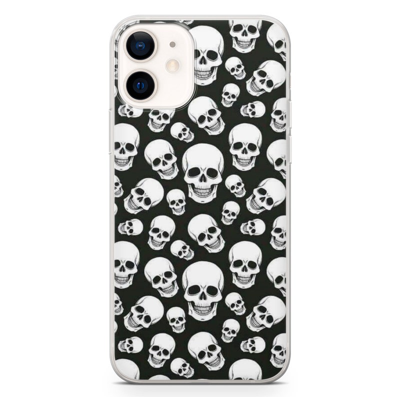 May include: A clear phone case with a black background and a white skull pattern.