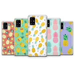 May include: A collection of five phone cases with pineapple designs. The cases feature various patterns, including repeating pineapples on coral, green, white, and lavender backgrounds. Some pineapples have sunglasses or smiling faces.