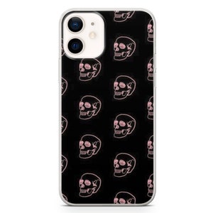 May include: A clear phone case with a black background and a repeating pattern of pink skulls.