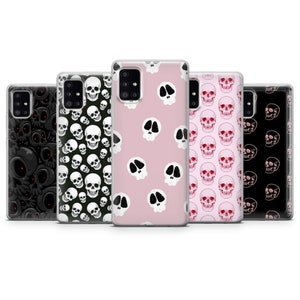 May include: Five different phone cases with skull designs. The cases are clear and show a variety of skull patterns in black, white, pink, and red.