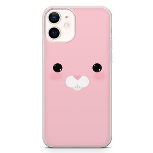 Puede incluir: Una funda de tel&eacute;fono rosa con una linda cara de conejo de dibujos animados. El conejo tiene ojos negros, una nariz blanca y una peque&ntilde;a boca.