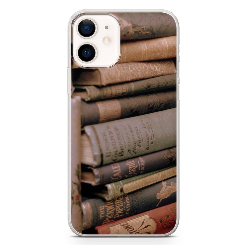 May include: A stack of vintage hardcover books with brown, blue, and red spines. The titles on the spines include "Under Colony's Banner", "A Story of Huguenot France", and "The Pickwick Papers".