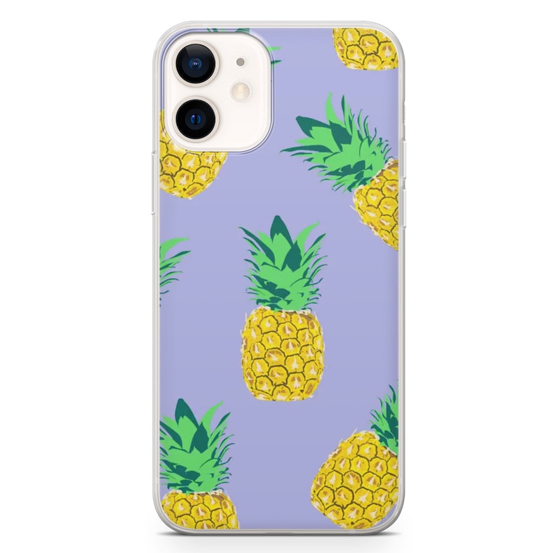 May include: Clear phone case with a repeating pattern of yellow pineapples with green tops on a light purple background. The phone case has a clear border and a camera cutout.