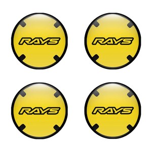 Peut inclure: Quatre autocollants circulaires jaunes avec des contours noirs et le mot "RAYS" en lettres noires.