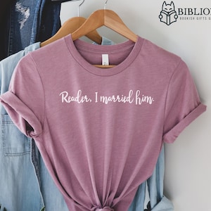 May include: A heather orchid coloured t-shirt with the text "Reader, I married him." printed in white on the front.