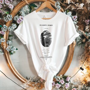 May include: White t-shirt with a black and white illustration of a tree and the text "Wuthering Heights, A Novel" printed on the front.