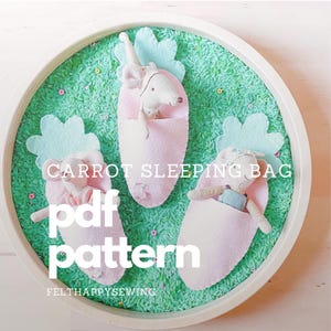 May include: Three pink felt carrot sleeping bags with green felt tops and a white felt flower detail. The sleeping bags are filled with small stuffed animals. The text "CARROT SLEEPING BAG pdf pattern FELTHAPPYSEWING" is printed on the image.