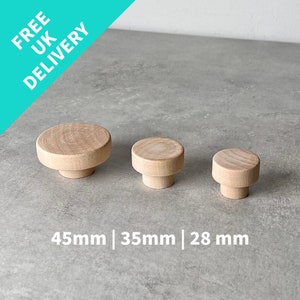 May include: Three wooden knobs in different sizes, 45mm, 35mm, and 28mm. The knobs are round and have a smooth, natural wood finish.