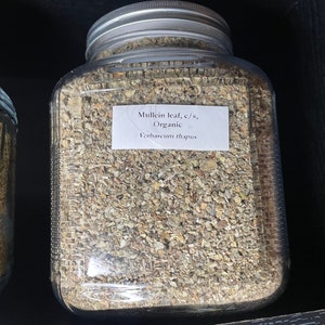 May include: A glass jar filled with dried, light brown mullein leaf, labeled "Mullein leaf, c/s, Organic Verbascum thapsus".