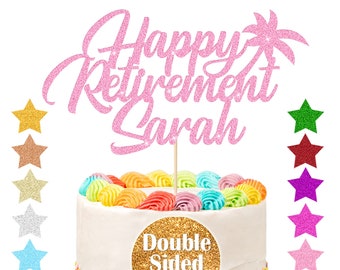 May include: Pink glitter cake topper with the text "Happy Retirement Sarah" and a palm tree. The topper is on a white cake with rainbow frosting and sprinkles. The cake topper is double-sided glitter.