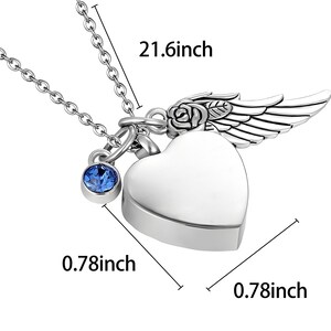 May include: A silver-colored heart-shaped pendant necklace with a blue gemstone charm. The pendant has a wing and rose design. The chain is 21.6 inches long, and the pendant is 0.78 inches wide.