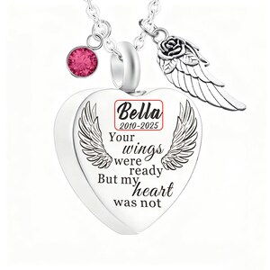 May include: A silver heart-shaped pendant necklace with engraved wings and the text "Your wings were ready but my heart was not." Includes a pink gemstone and a rose with a wing charm. The name "Bella" and dates 2010-2025 are also visible.