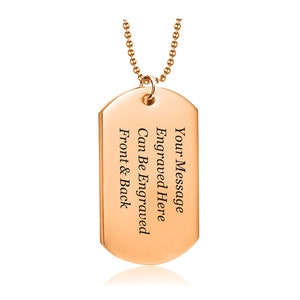 May include: Rose gold dog tag necklace with a chain. The tag is engraved with the text "Your Message Engraved Here Can Be Engraved Front & Back".