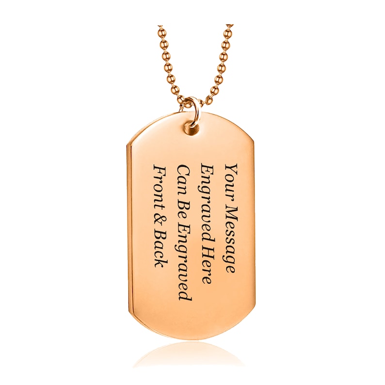 May include: Rose gold dog tag necklace with a chain. The tag is engraved with the text "Your Message Engraved Here Can Be Engraved Front & Back".