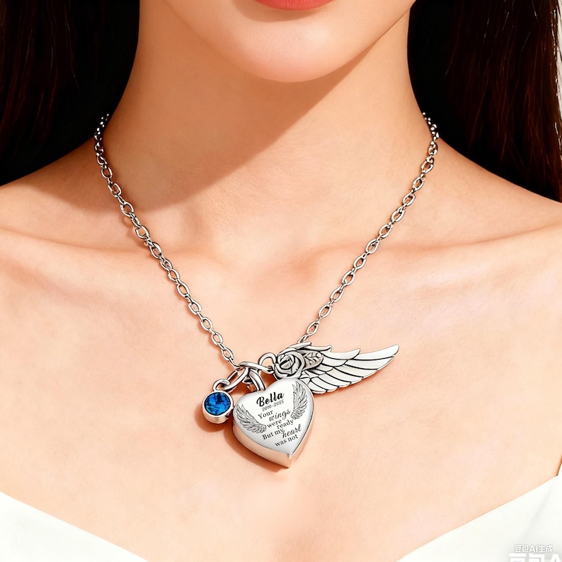 May include: Silver-toned necklace with a heart-shaped pendant, a blue gemstone, and a wing charm. The heart pendant has the inscription "Bella, Your wings were ready, But my heart was not."