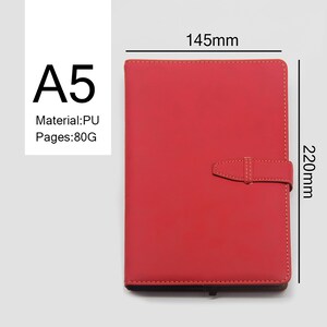 May include: A red A5 notebook with a PU cover and 80g pages. The notebook measures 145mm by 220mm and has a strap closure.