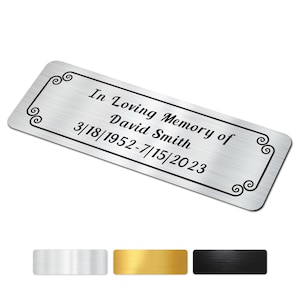 May include: A rectangular silver plaque with the inscription "In Loving Memory of David Smith 3/18/1952-7/15/2023". The plaque has a decorative black border with scroll accents. Three color options are shown below the plaque.