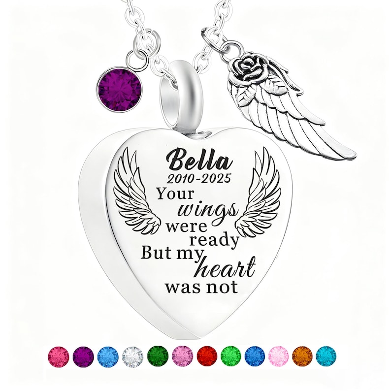 May include: A silver heart-shaped pendant necklace with the inscription "Bella 2010-2025 Your wings were ready But my heart was not." Features a purple gemstone and a rose with wing charm. A memorial jewelry piece.