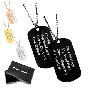 May include: Two black dog tag necklaces with silver chains. The tags are engraved with the text "Your Message Engraved Here Can Be Engraved Front & Back".