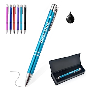 May include: A blue pen with the text "Best Dad" and a heart symbol, alongside a black ink drop. The pen is displayed with a black gift box and a set of six pens in various colors: purple, blue, red, purple, blue, and black.