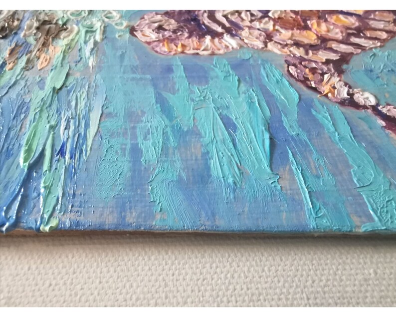 May include: A close-up of a textured blue and green abstract painting with thick brushstrokes. The painting is on a wooden canvas.