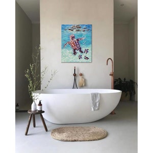 May include: A painting of a sea turtle swimming in the ocean with three smaller turtles following behind. The painting is in a bathroom setting with a white bathtub and a copper faucet.