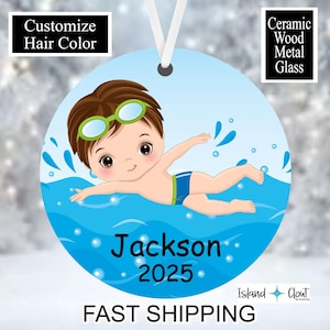 May include: A blue and green Christmas ornament featuring a cartoon boy swimming in a pool. The ornament is personalized with the name "Jackson" and the year "2025".