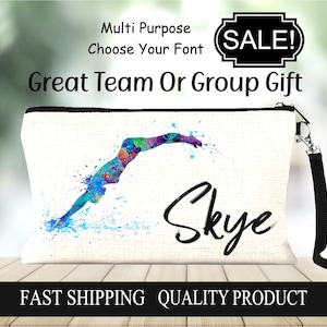 May include: A white canvas makeup bag with a black zipper and a black strap. The bag features a watercolor illustration of a swimmer diving into water with the name "Skye" written in black cursive. The bag has the text "Multi Purpose Choose Your Font Great Team Or Group Gift FAST SHIPPING QUALITY PRODUCT" printed on it.