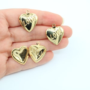 May include: Four gold-tone heart-shaped locket charms with the word "LOVE" engraved on the front.