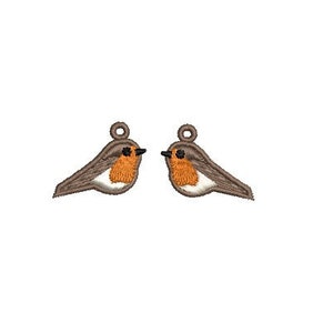 May include: Two brown and orange robin bird charms with black eyes. The charms have a loop at the top for hanging.