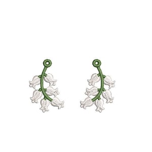 Puede incluir: Dos ramitas bordadas de lirios de los valles. Cada ramita presenta flores blancas en forma de campana sobre un tallo verde. El diseño es detallado y parece estar bordado a máquina, adecuado para manualidades o adornos.