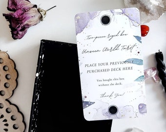 May include: A white card with a watercolor background and gold accents. The card says "Two-piece rigid box Unseen World Tarot" and "Place your previously purchased deck here. You bought this box without the deck. Thank you!"