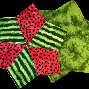 May include: Two star-shaped pot holders. One is red and green with a watermelon pattern and the other is green with a tie-dye pattern.