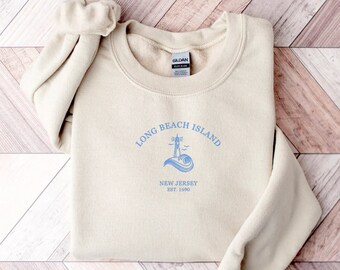 May include: A beige sweatshirt with a blue graphic print that says "Long Beach Island, New Jersey Est. 1880".